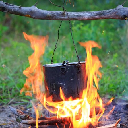 Smoked tourist ketle on camp fireの写真素材