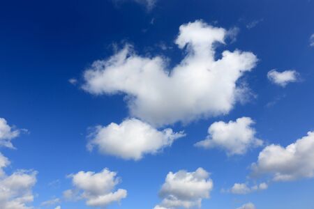 white cumulus clouds in blue skyの写真素材