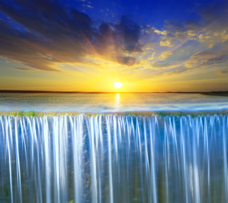 Scene with waterfall on sunset sky 
