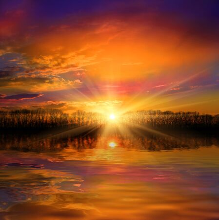 sunset over lake water surfaceの写真素材