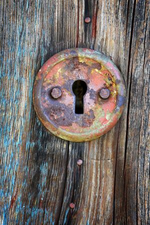 Old keyhole on aged wooden doorの写真素材