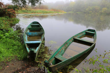 old flooded wooden boats on riverの写真素材