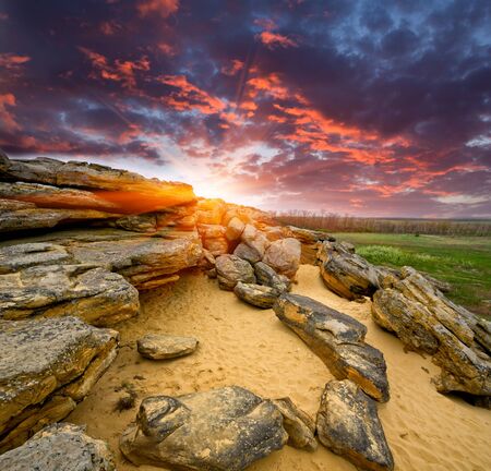 Landscape with stones desert on sunset backgroundの写真素材