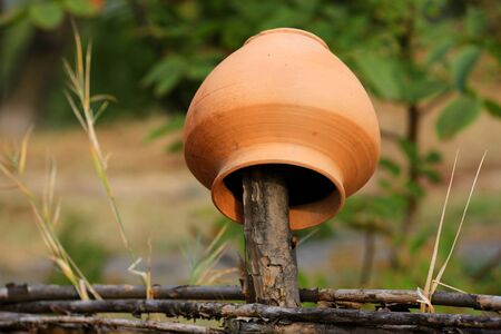 Traditional Ukrainian clay jug on wooden fence, take it in Oposhnya Village, Ukraineの写真素材