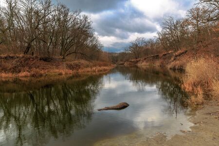 landscape with river at cloudy autumn dayの写真素材