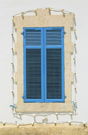 Blue vintage window and white wallの写真素材