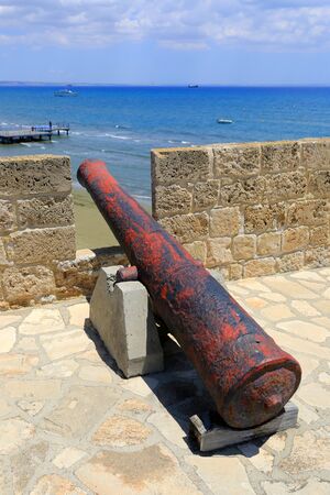 Old gun in Larnaka Medieval Castle over sea, Cyprusの写真素材