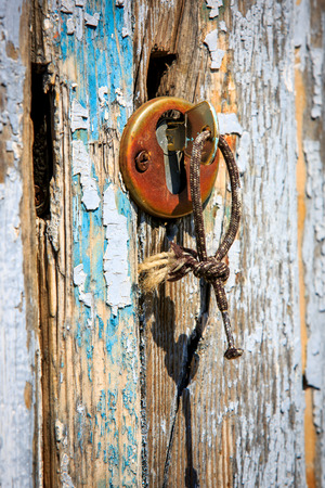 key in keyhole on vintage wooden doorの写真素材