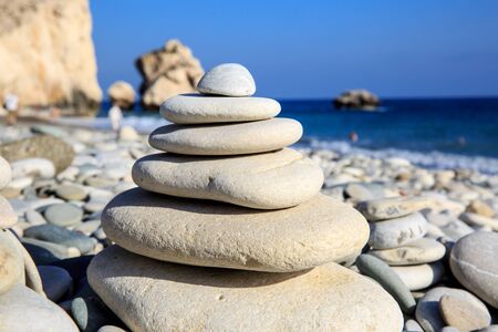 abstract balanced stones on sea in sunny day