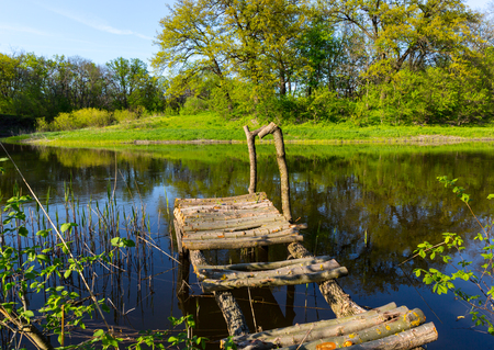 Wooden fishing bridge on riverの写真素材
