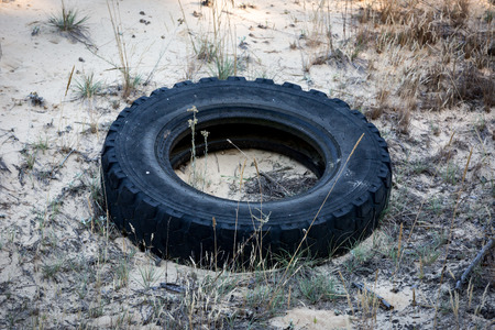 abstract broken tire in sandsの写真素材