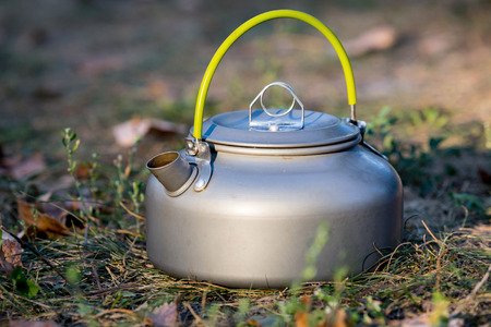 tourist kettle on grass in meadowの写真素材