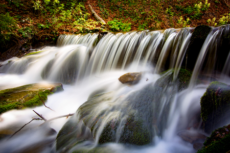 Nice waterfall in autumn forestの写真素材