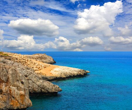 Landscape with rocky shore on seaの写真素材