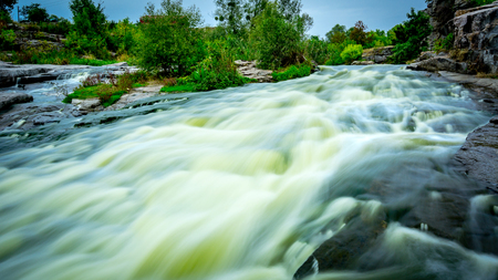 Scene with run of river among stones after rainの写真素材