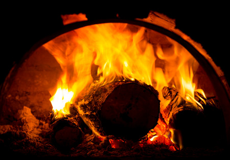 hot fire of burning logs in ovenの写真素材