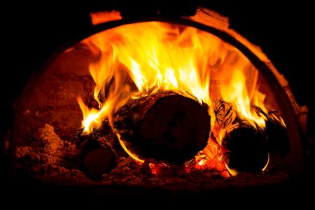 burning wooden logs in ovenの写真素材