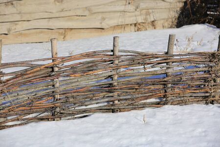 abstrat wooden wattle fence in winter dayの写真素材