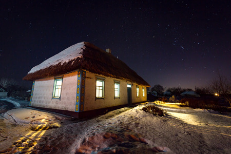 night scene with old house with thach roofの写真素材