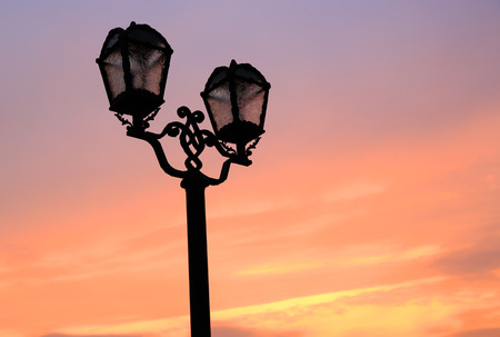 old style street lamps on red sunset sky backgroundの写真素材