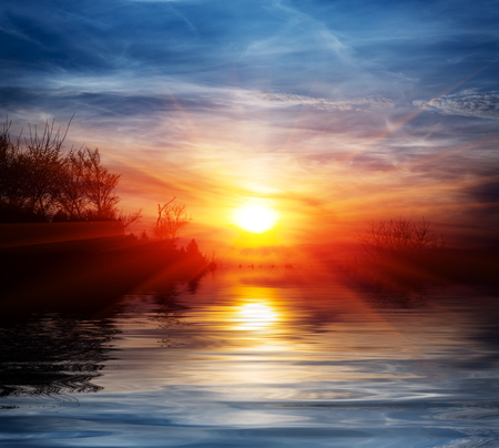 Sunset scene over lake water surfaceの写真素材