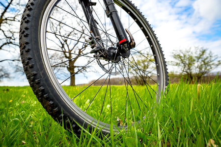 bike wheel on meadow in spring timeの写真素材