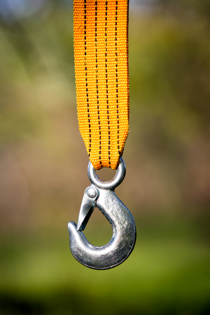 abstract steel hook on yellow strapの写真素材