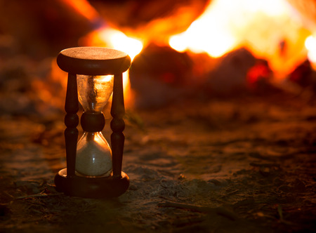 vintage hourglass on fire background in darknessの写真素材