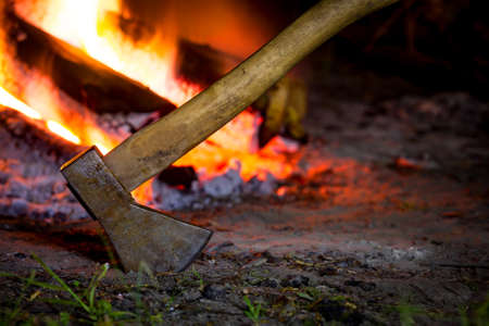 Axe in darkness against hot fireの写真素材