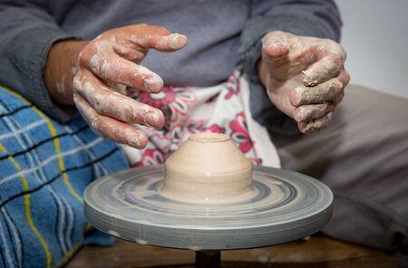 potter man hands make clay jugの写真素材