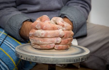 hands of potter man make clay jugの写真素材
