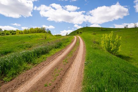 road to cross on top green hillの写真素材