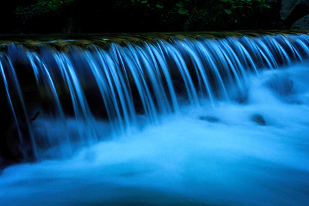 Small waterfall on mountain riverの写真素材