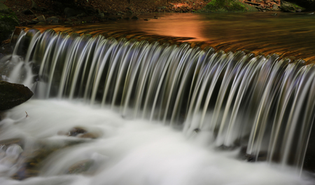 nice waterfall cascade on mountain riverの写真素材