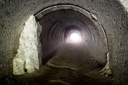 Old lost undergound tunnel with light in endの写真素材