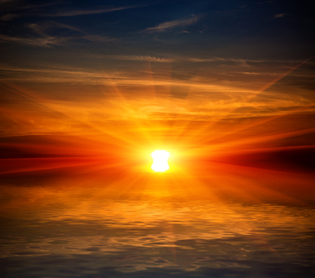 Sunset scene over water surface with reflectionの写真素材