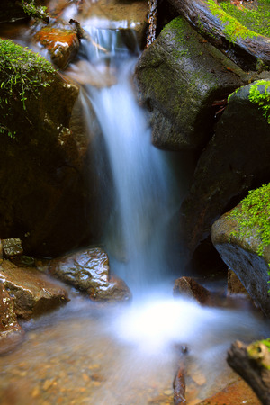 nice small waterfall on mountain riverの写真素材