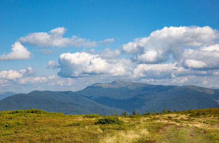 nice landscape with white clouds in blue sky over Carpathian mountains, Ukraineの写真素材