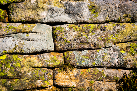 old stone with moss in wallの写真素材