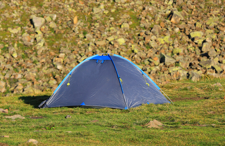 Modern tourist tent on mountain meadowの写真素材