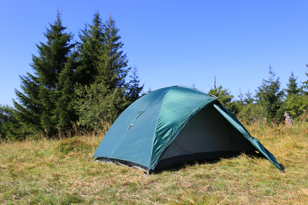 tourist tent on meadow in sunny dayの写真素材