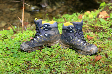 pair of tourist boots on forest meadowの写真素材
