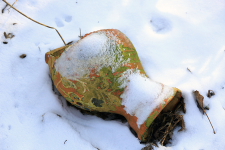 Broken clay jug in the snow. Take it in Ukraineの写真素材