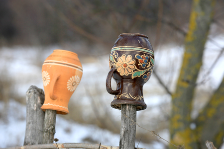 clay jugs on a wooden fence. Take it in Ukraineの写真素材