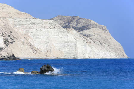 Stone in sea against white rock backgroundの写真素材
