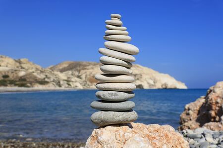Balanced pebbles stones pyramid on sea shoreの写真素材