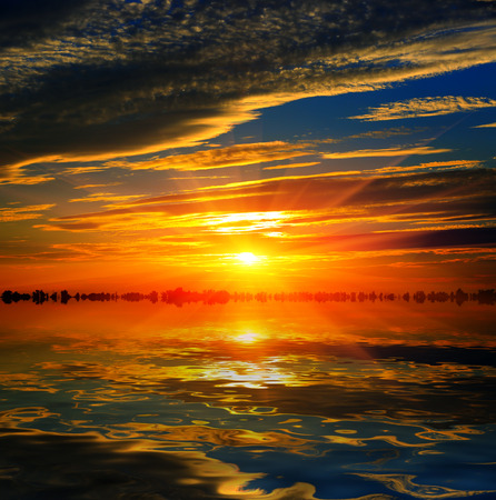 Sunset scene over water surfaceの写真素材
