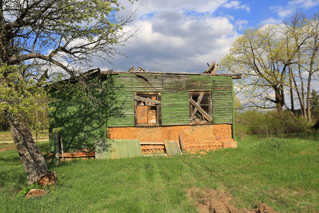 abandoned old rural house on meadowの写真素材