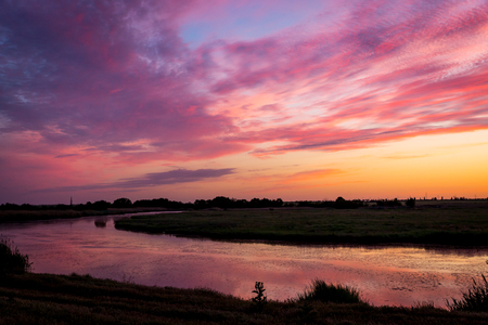 Evening landscape with sunset on riverの写真素材