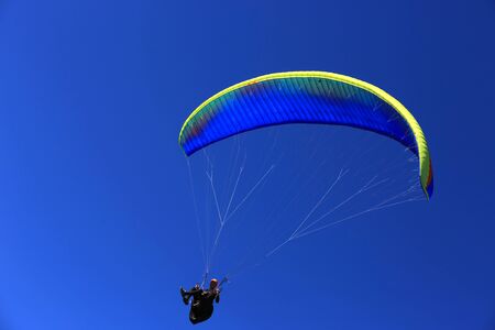 Paraglider fly in blue skyの写真素材